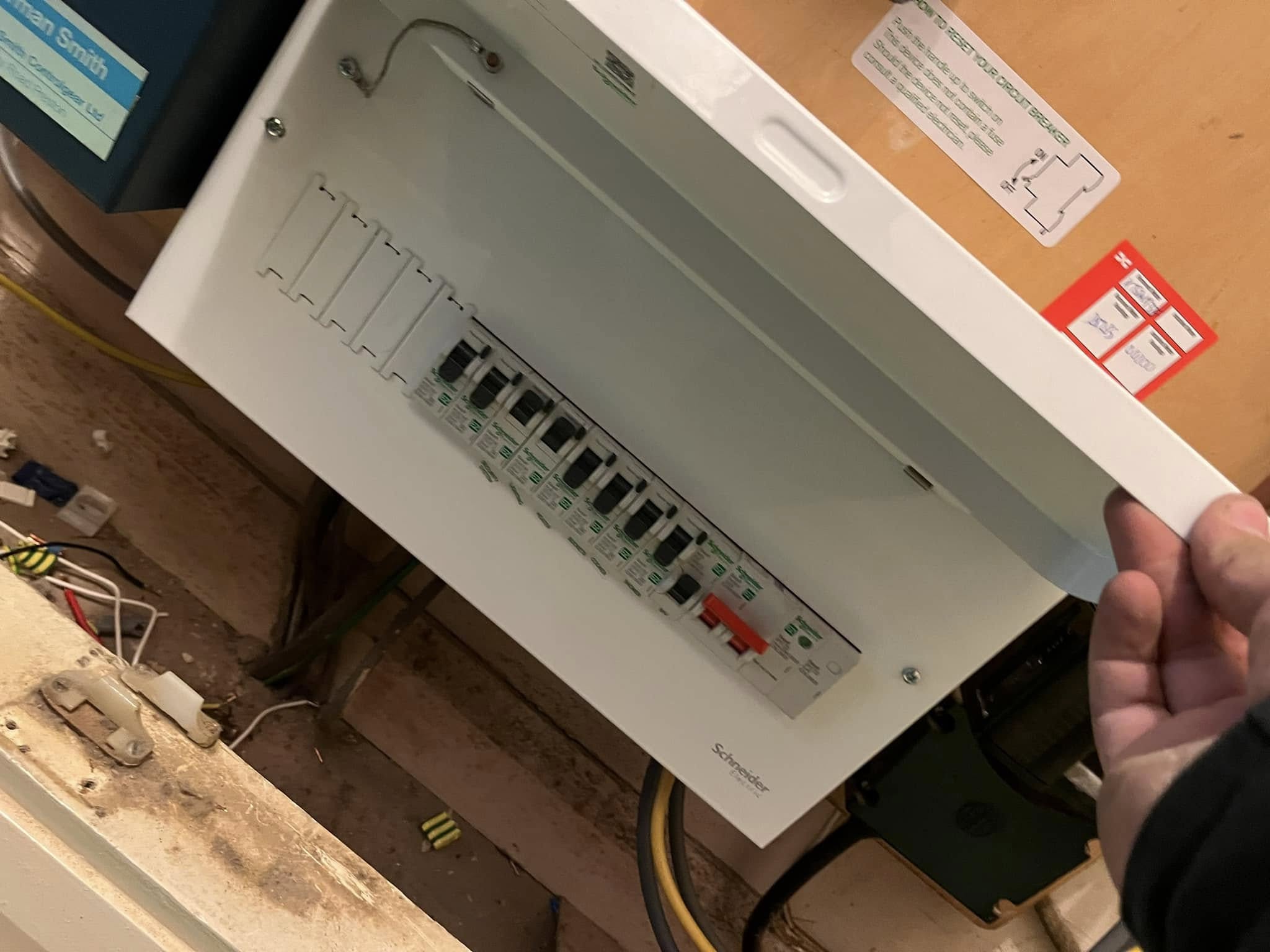 Man showing switches on Electrical fuse box